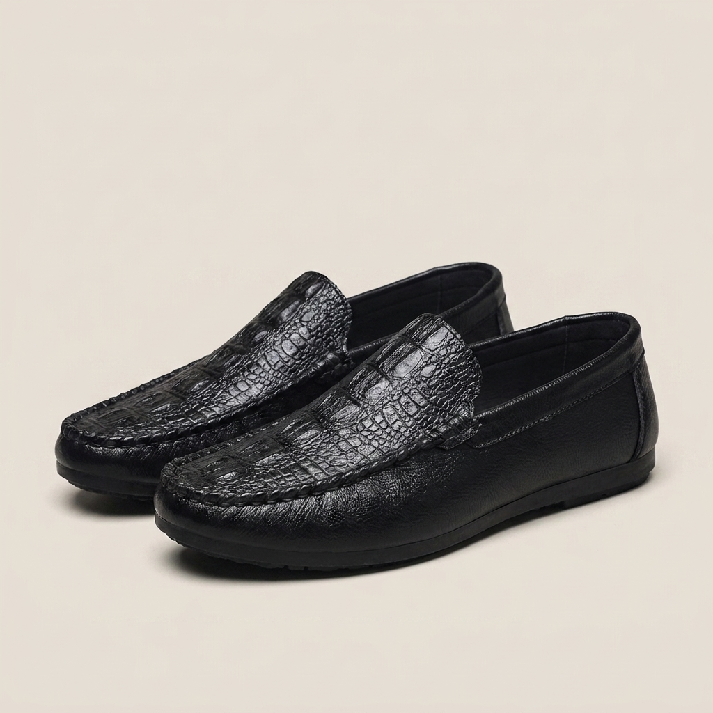 Synthetic leather black crocodile-grain slip-on loafer shown front view with round toe and visible stitch detailing