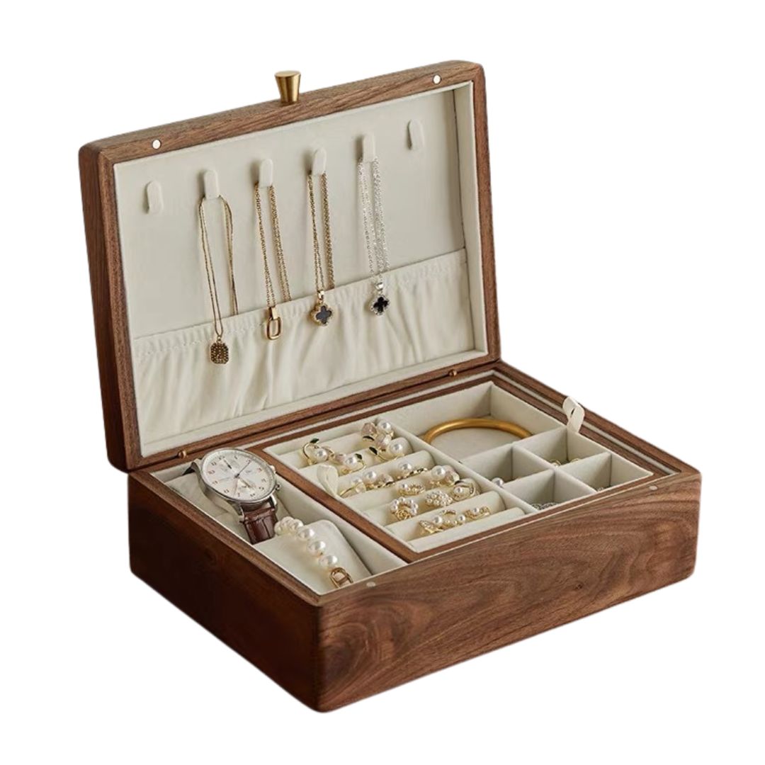 Open solid walnut wood jewelry box with a removable tray, showcasing necklaces, a watch, bracelets, and rings against a cream-colored interior lining. Perfect for elegant jewelry organization.