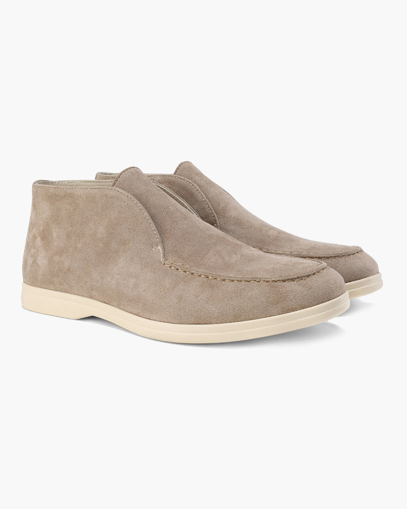 A pair of mocha brown suede loafers with classic detailing, featuring a mid-cut design, presented on a clean white background.