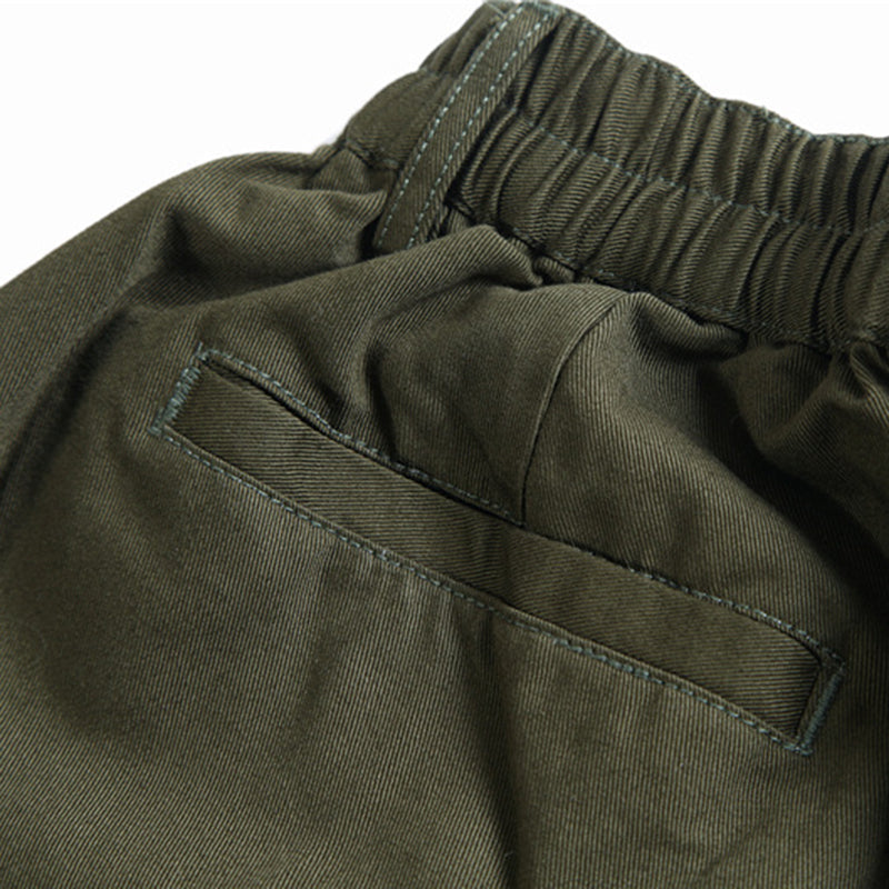 Close-up view of the back of Urban Luxe wide-leg casual pants in green, highlighting the elastic waistband, a detailed back welt pocket, and the soft fabric texture.