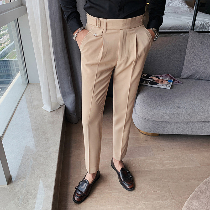 Men's Vintage Charm retro suit pants in khaki, featuring a lightweight fabric and tailored fit. Model wears pleated pants with a black shirt and brown loafers, showcasing the side buckle detail. Perfect for a stylish business casual look.