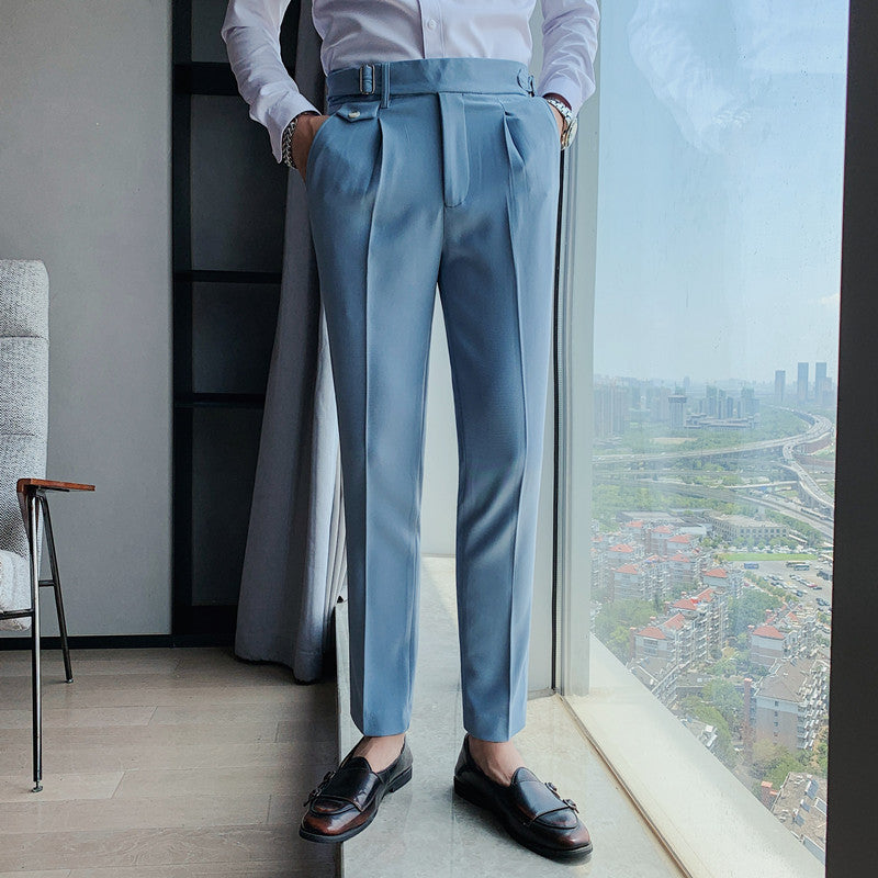 Men's Vintage Charm retro suit pants in sky blue, featuring a lightweight fabric and tailored fit. Model wears pleated pants with a white shirt and brown loafers, showcasing the side buckle detail. Offers a comfortable and stylish vintage look.