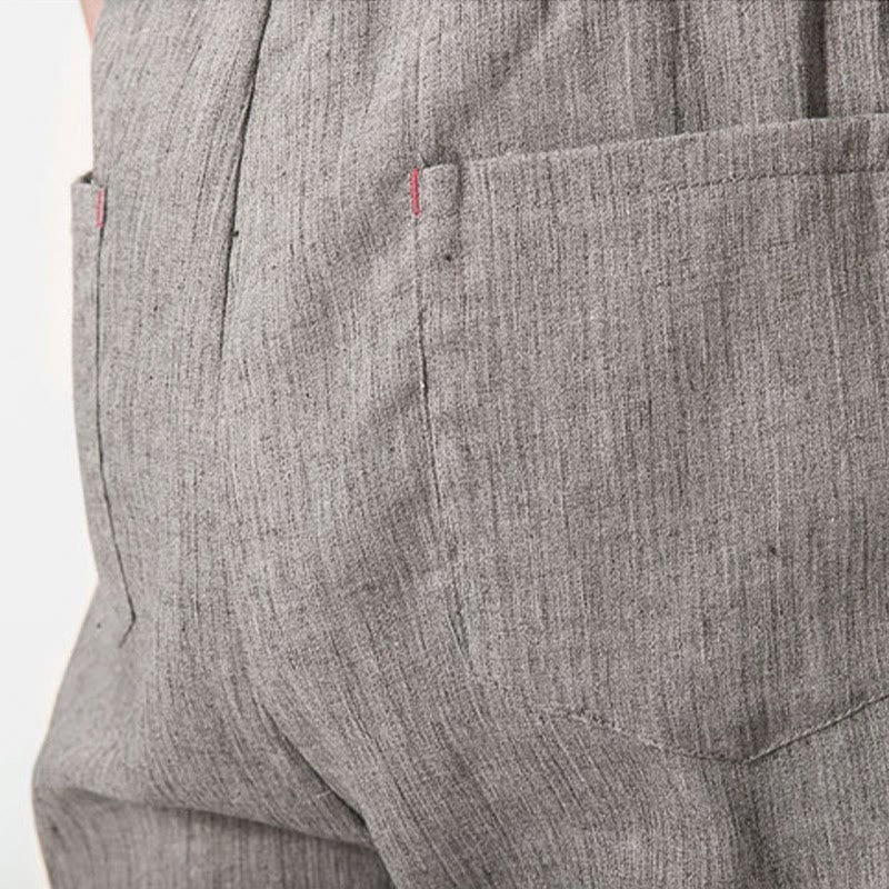 Close-up of the back pocket on Zenith Stones gray linen men's pants, featuring subtle red stitching detail.
